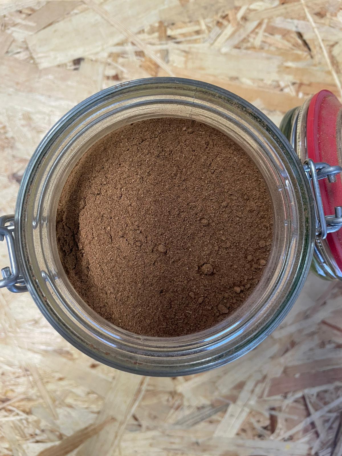 Glass jar containing clove powder sold at the eco basket