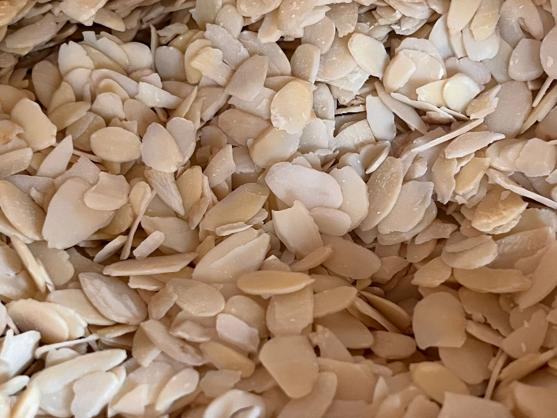 Bulk flaked almonds from The Eco Basket, showing thin, pale almond slices ready for cooking, baking, or snacking.”